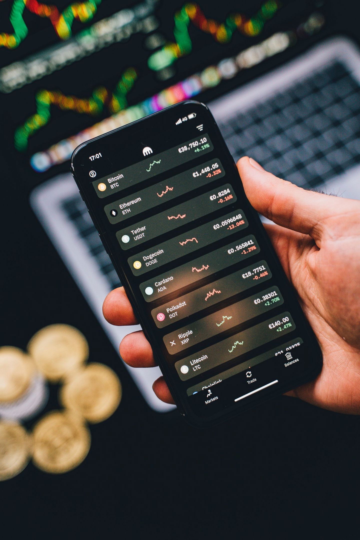 Hand holding phone showing cryptocurrency tre