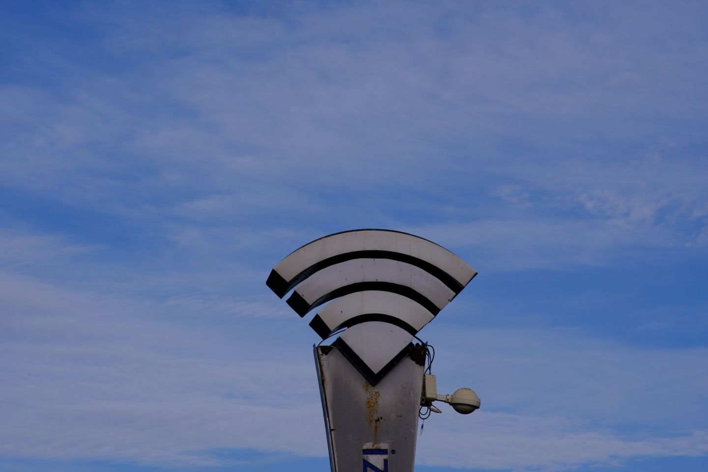 A WiFi symbol sculpture set against a clear b