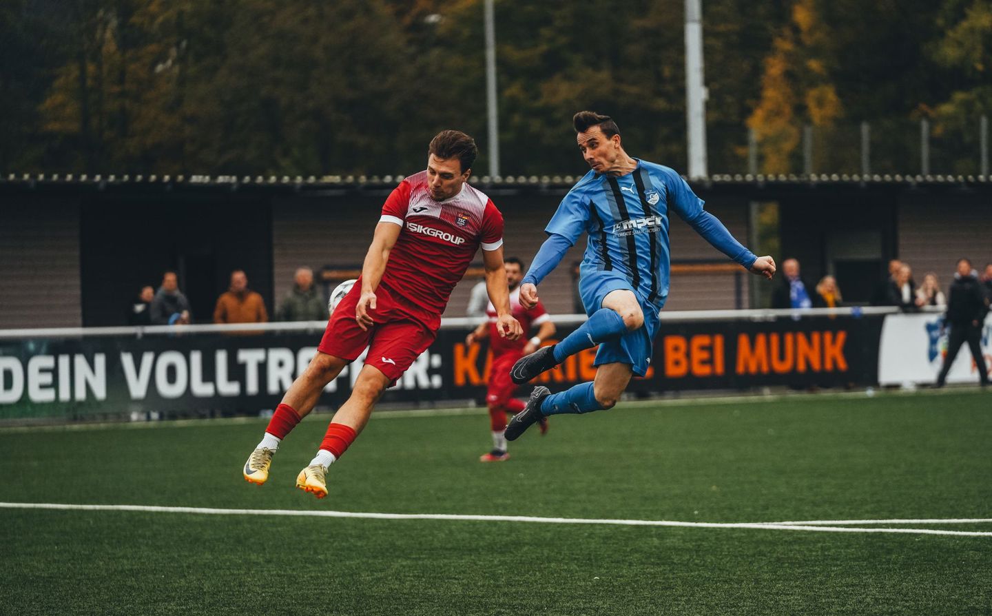 Two soccer players compete fiercely during a