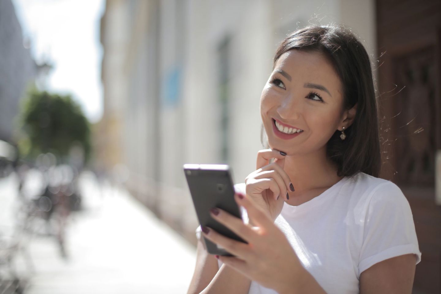 A happy woman with a smartphone, enjoying a s