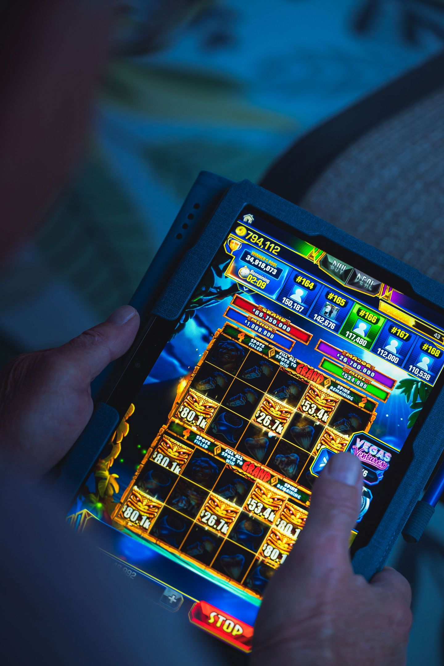 Person playing a mobile gaming app on a table