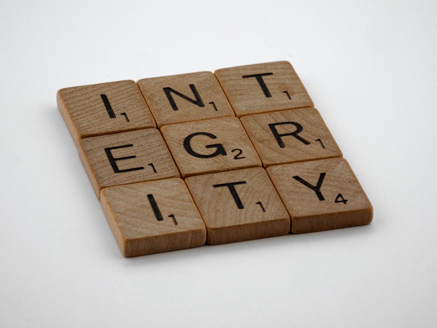 Wooden scrabble tiles spelling 'INTEGRITY' on