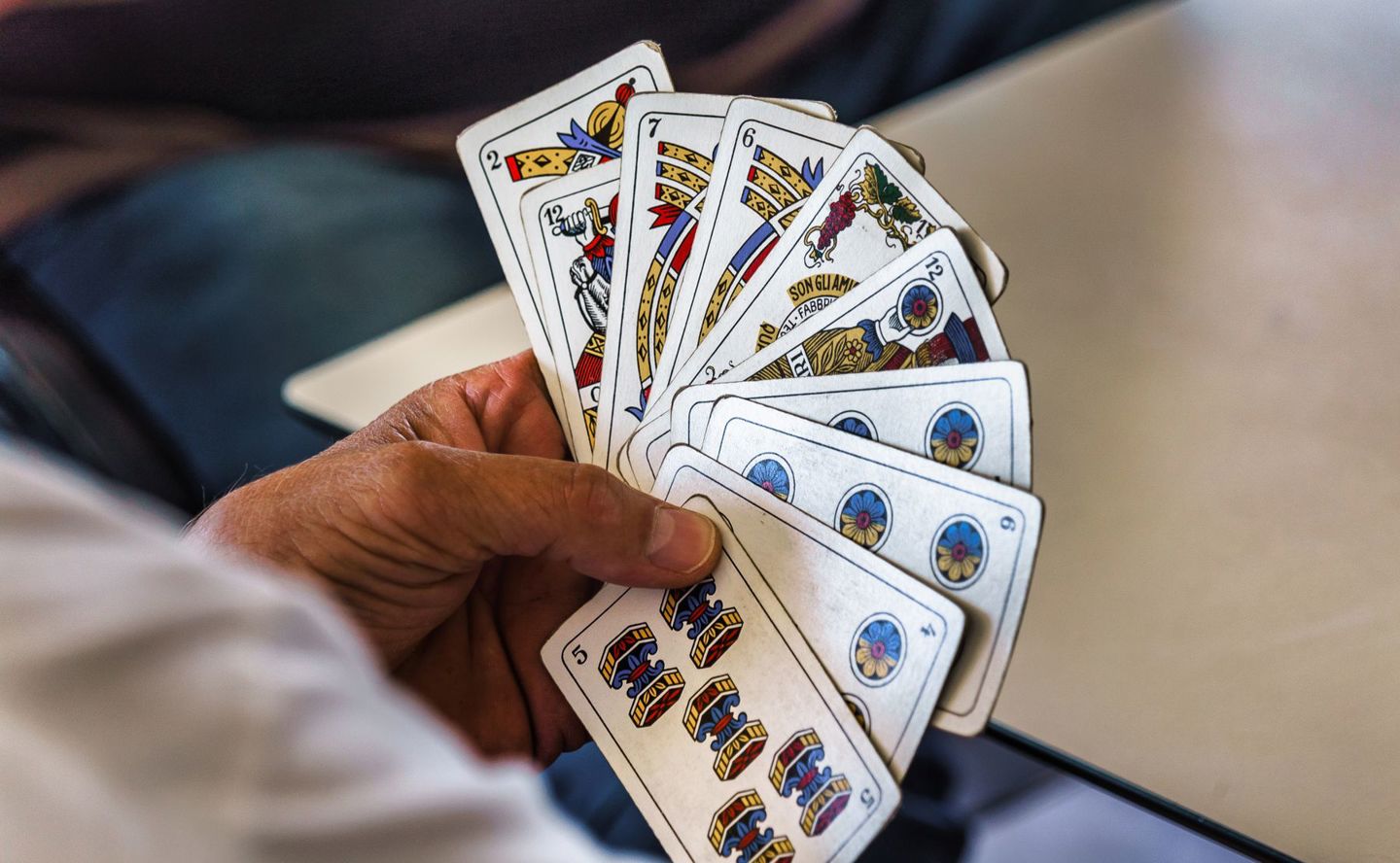 Close-up of a hand holding a fan of tradition