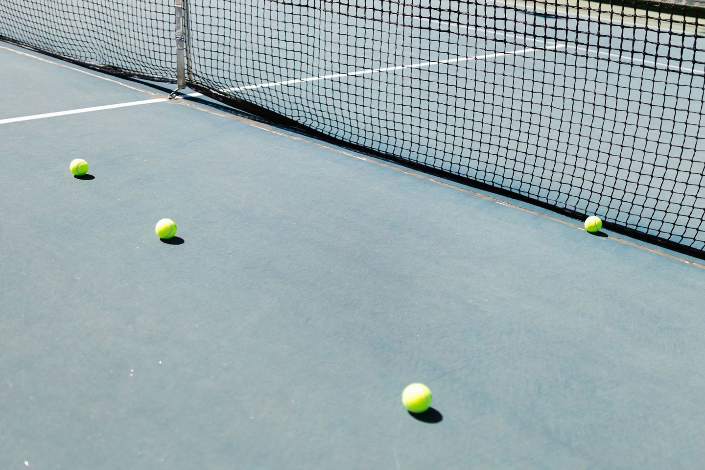 A tennis court featuring a net and several te