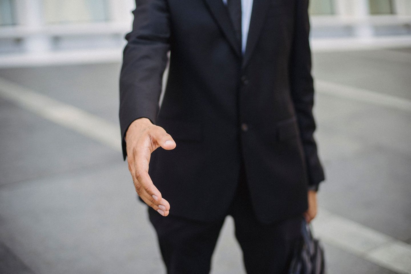 Close-up of a businessman in a suit reaching