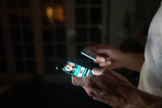 man-betting-online-at-home-on-his-cell-phone