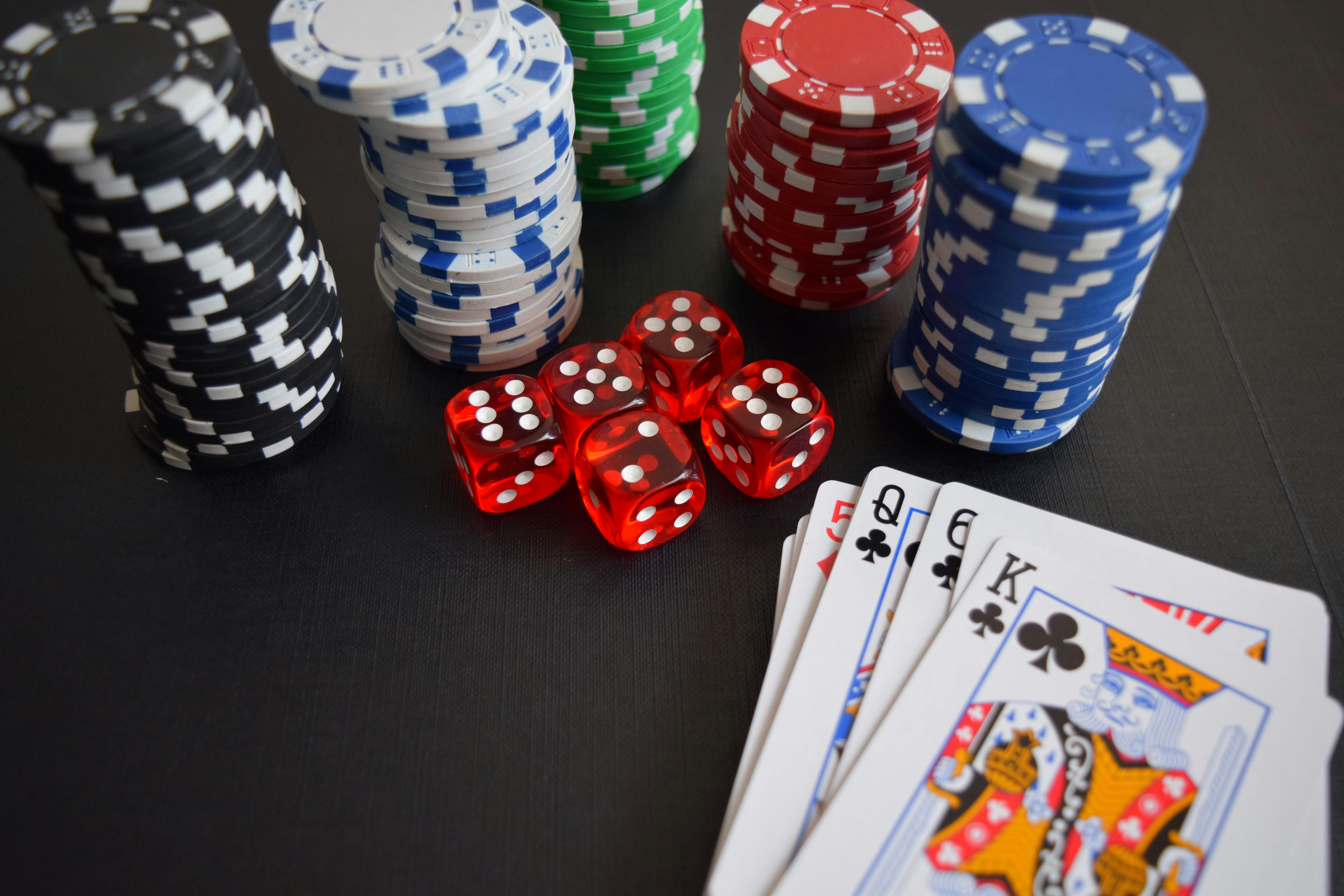 Photo of stacks of casino chips, cards and dice