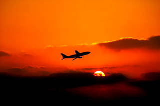 flying-airplane-over-sunset
