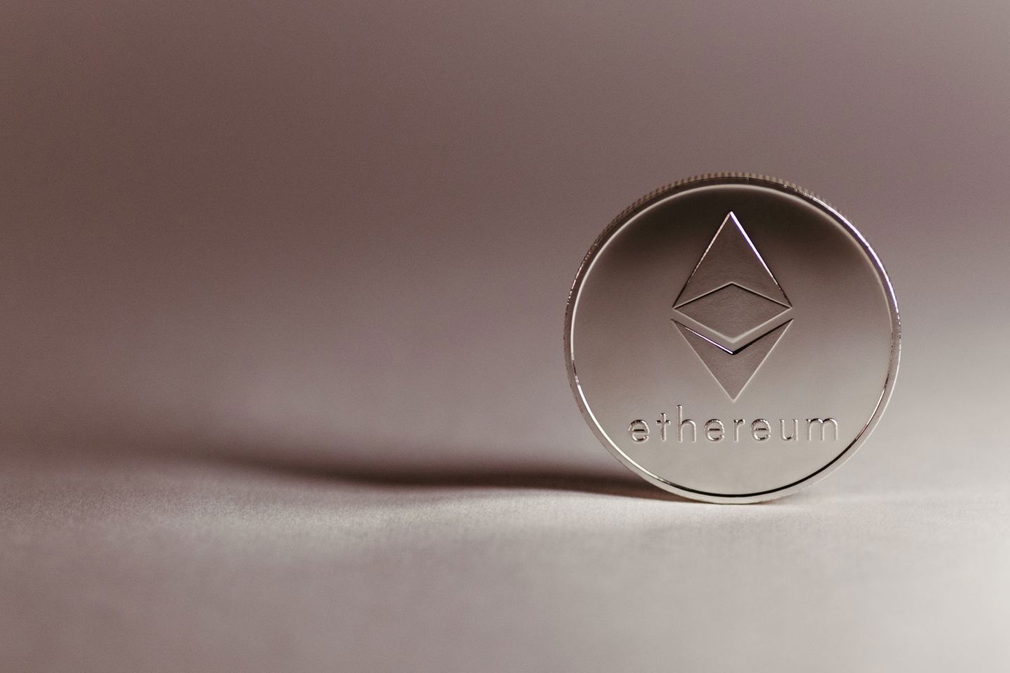 Close-up of a silver Ethereum coin symbolizin